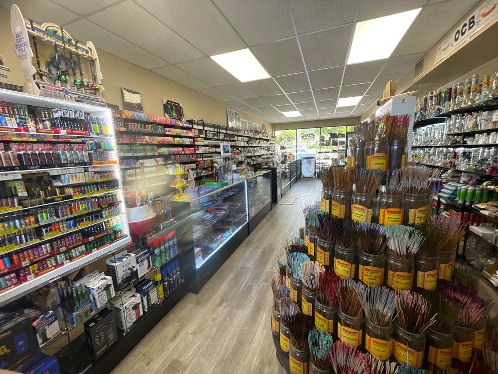 Interior aisle with PeacePipe Smoke Shop display shelves.