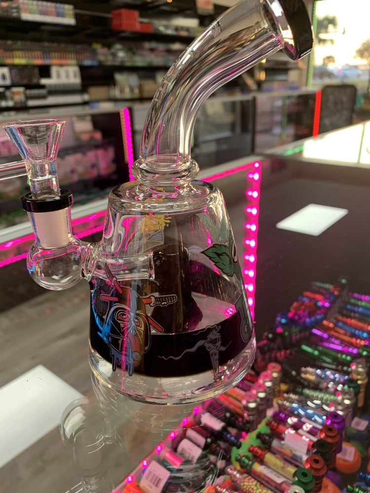 A bubbler displayed with other popular PeacePipe glass items.