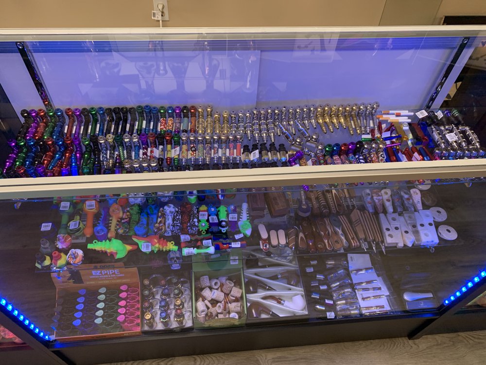 Glass pipes displayed on shelves inside PeacePipe Smoke Shop.