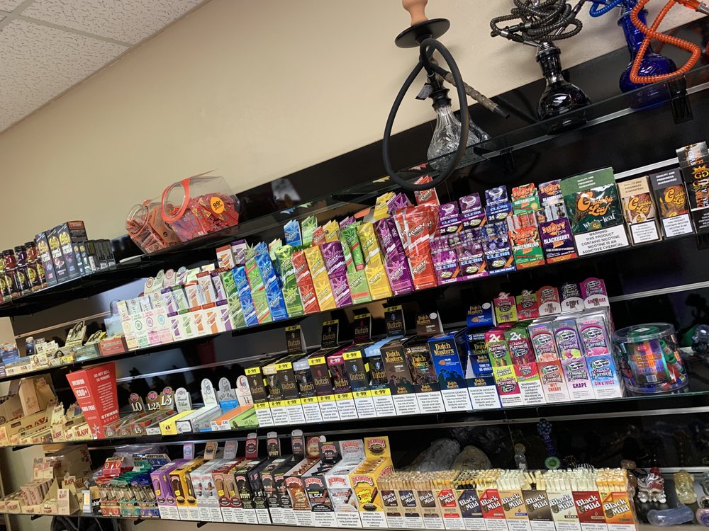 Rolling paper and smoke shop supplies arranged on a PeacePipe product wall.